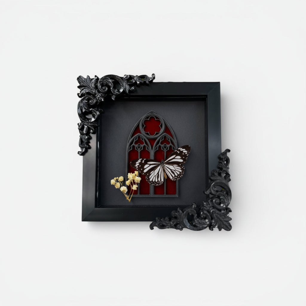 Decorative shadow box with butterfly and floral arrangement on a white background